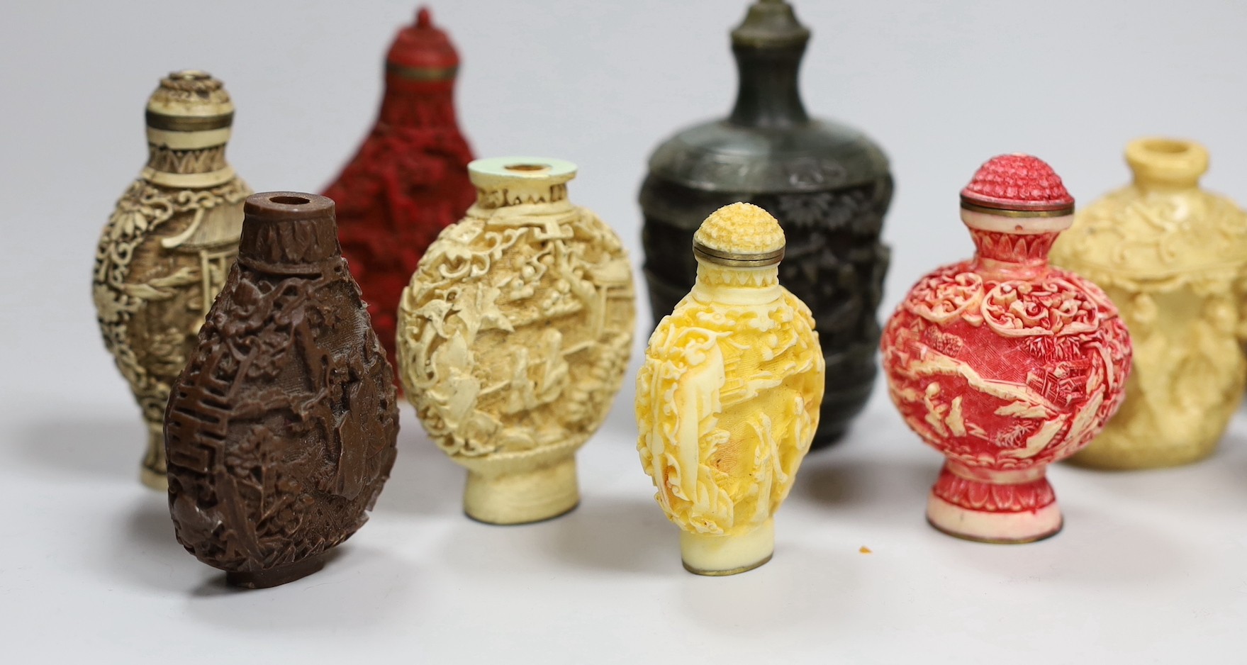 A large Chinese 20th century carved snuff bottle and smaller snuff bottles, all resin